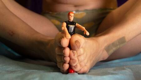 Little guy between giantess feet