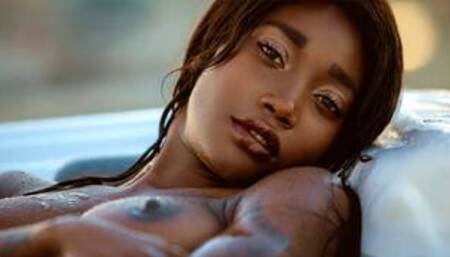 Ebony beauty from Cameroon Mimi Desuka gets naked in a pool for Playboy