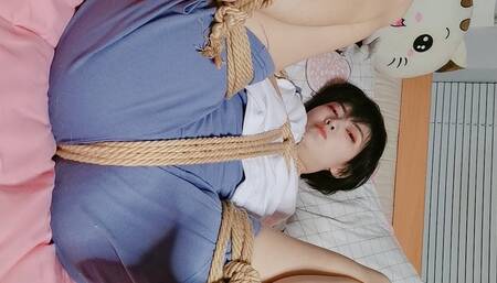 Tied up and struggling in bed in tracksuit