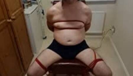 Soon to be naked man tied to chair by femdom