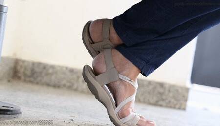 Candid foot fetish pose in sandals, nice arched feet close-up