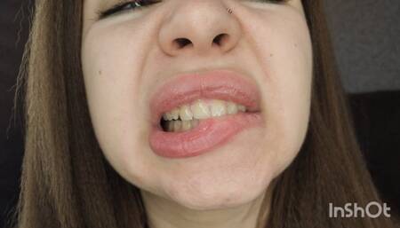 Demonstration of a wide mouth, deep throat, and sharp teeth