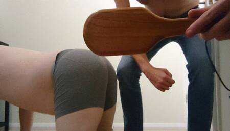 Spanking my slave with a tough paddle