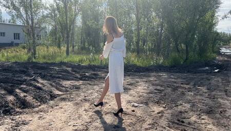 girl in high-heeled leather shoes was walking along the road and got into a lot of mud, her feet literally went down into deep mud