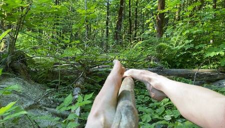 Footjob on wood in nature