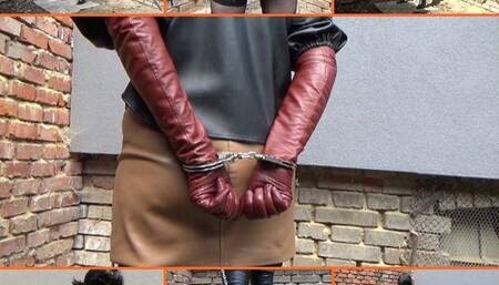 Handcuffed wife in leather and long cinnamon gloves