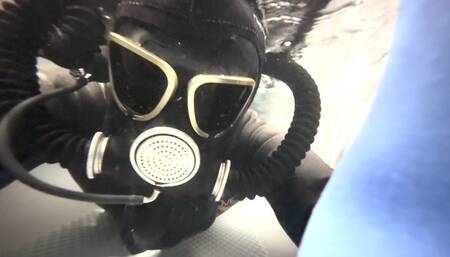 Female Wetsuit Dives in Gasmask Underwater