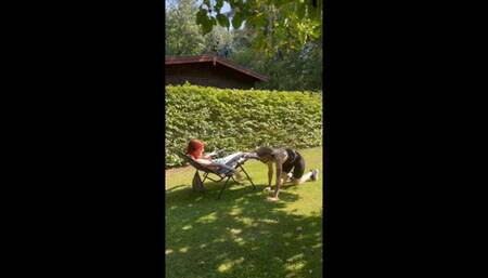 Submissive slave girl publicly worships the feet of the Goddess