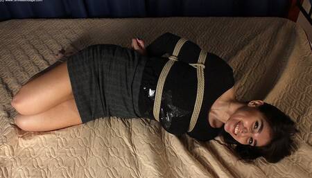 Lillian: hogtied barefoot girl, dressed in top and skirt, is wiggling and rolling on the bed, enjoying her first time in bondage (HD MOV)