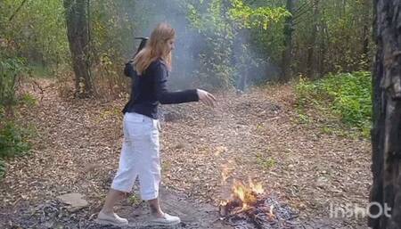 Tearing and burning clothes in the woods