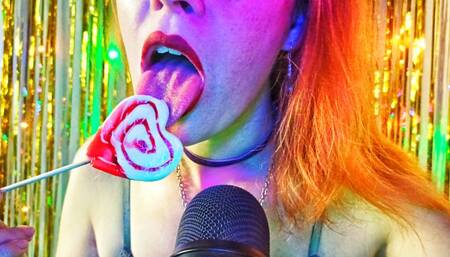 A redhead girl sensually licks a heart-shaped candy