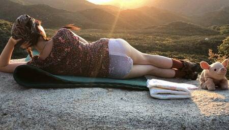 Diaper girl posing outdoors with sunset