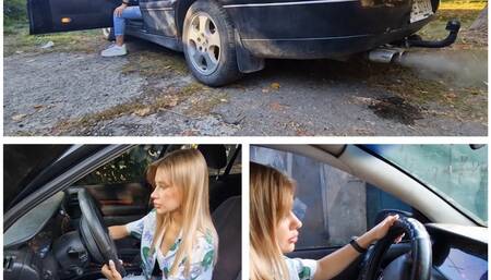Young beautiful Lucy trying to start an old Opel from a cranked up Lanos