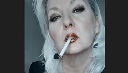 Queen Joan pulls seductively on a Winston Gold 100s with her red metallic lips