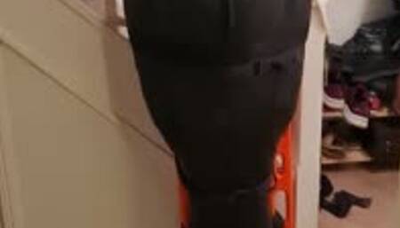 Man bound in neoprene sleepsack by woman