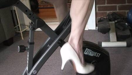 Lilly on the stationary bike, panning up to her biceps and back