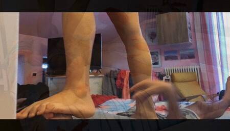 Ariel trampling barefeet on the bed