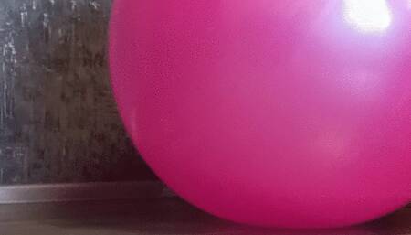 girl in jeans deflate pink gym ball
