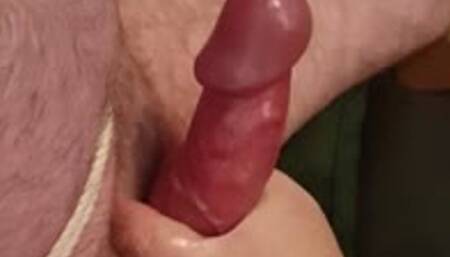 Polishing handjob on naked man tied to chair