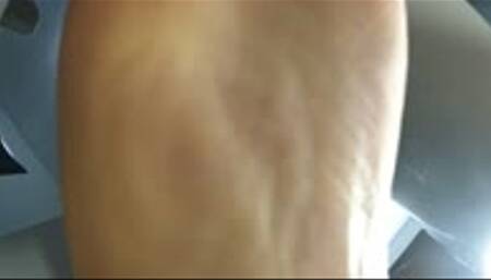 Playing with human foot stool watching tv