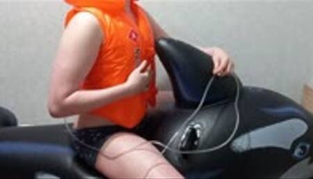 Inflating a swim vest with a pump while riding on a whale