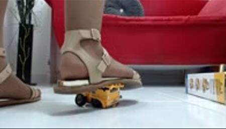 crushing a toyset with 3 construction truck in nylons and 3 sexy sandals