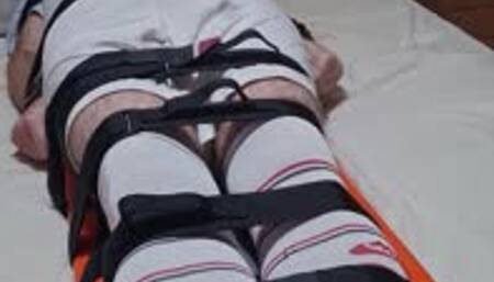 Feet tickling on strapped down footballer