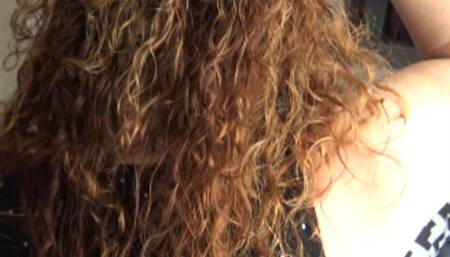 Leather gloves in long curly hair