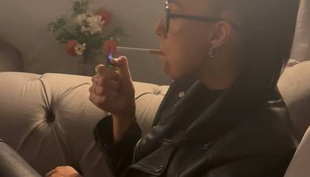 Smoking in full leather outfit on sofa