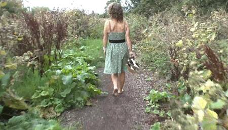 Zoe wandering barefoot along muddy path