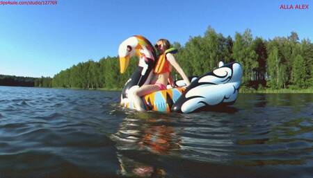 Alla wears an inflatable swimming vest and swims on the lake and climbs on an inflatable swan!!!