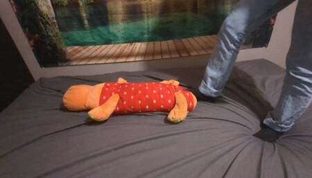 Sanda is crushing a big plushie with socks