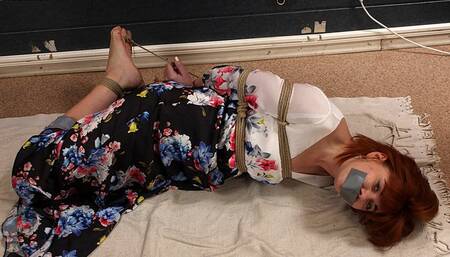 Tapegagged barefoot redhead Kathy in long flower dress, hogtied with her big toes tied, is getting her feet oiled and tickled (HD WMV)