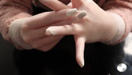 Shiny Surgical Gloves and Manicured Nails