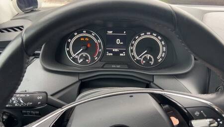 girl in high-heeled shoes drives a car and enjoys the sound of the engine, pressing the gas pedal