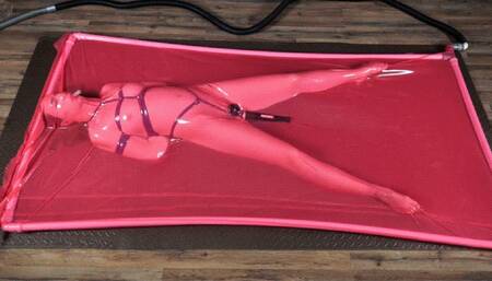 Rope bondage with vibro in a pink latex bed