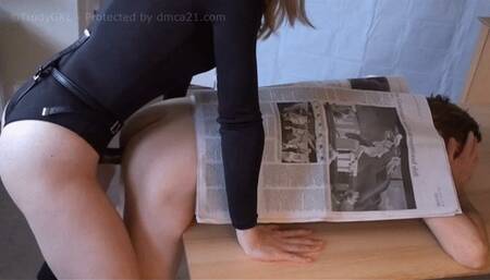 Strap-on eats cum off newspaper