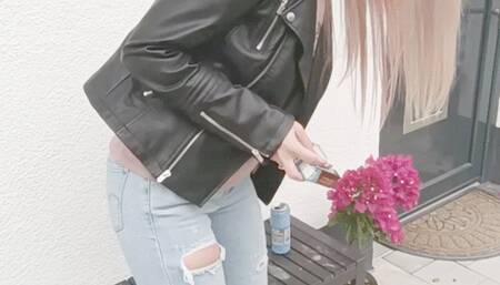 Casual smoking in leather jacket and tight ripped jeans