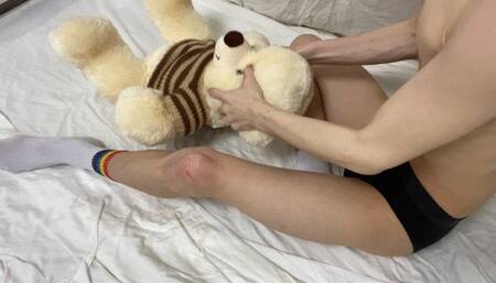 Cute boy destroys a teddy bear with his sexy thighs