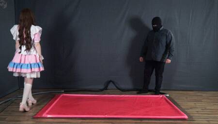 Tickle doll in a pink latex bed