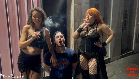 Human ashtray serves two Goddesses on the street