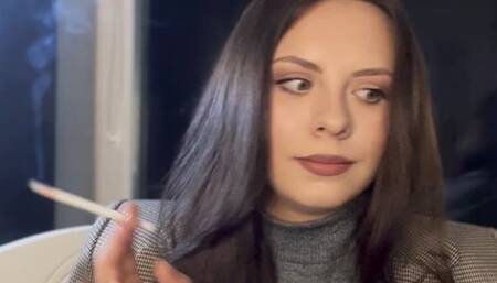 Smoking long white cigarette on classic stylish look