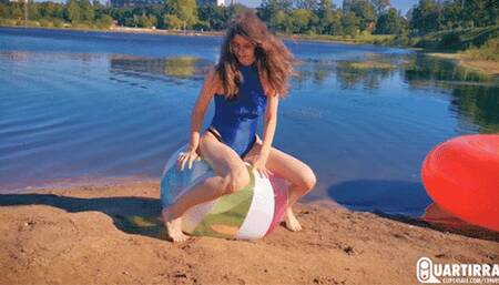 Q906 Cosette rides and deflates big beachball on a lake - 1080p
