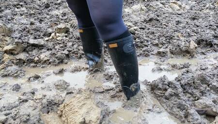 Muddy ground and black rubber boots