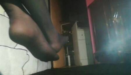 Mel in nylon feet on the chair