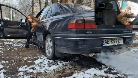 Nastya revving smoky Opel and produces exhaust fumes