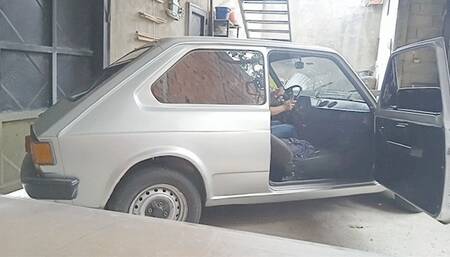 Barbara cranking the fiat to drive to the store (Outside exterior view)