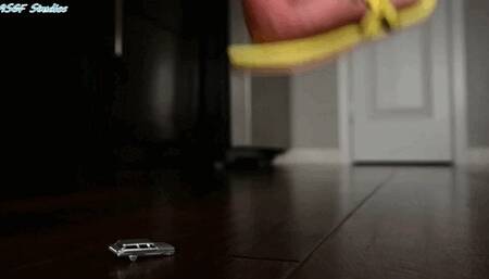 SMD walking around in her sandals unware of the tiny car crushed below! - MOV