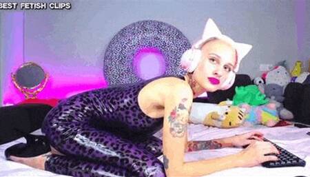 The cute bald fetish girl with the plush ears shows you how to put on a latex catsuit properly