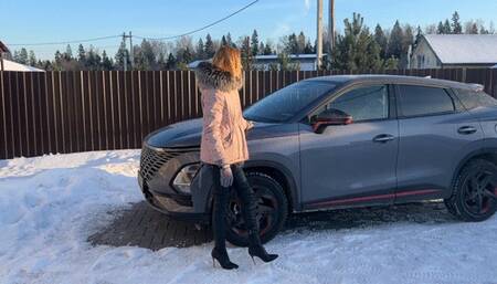 girl in high-heeled boots plays with car pedals